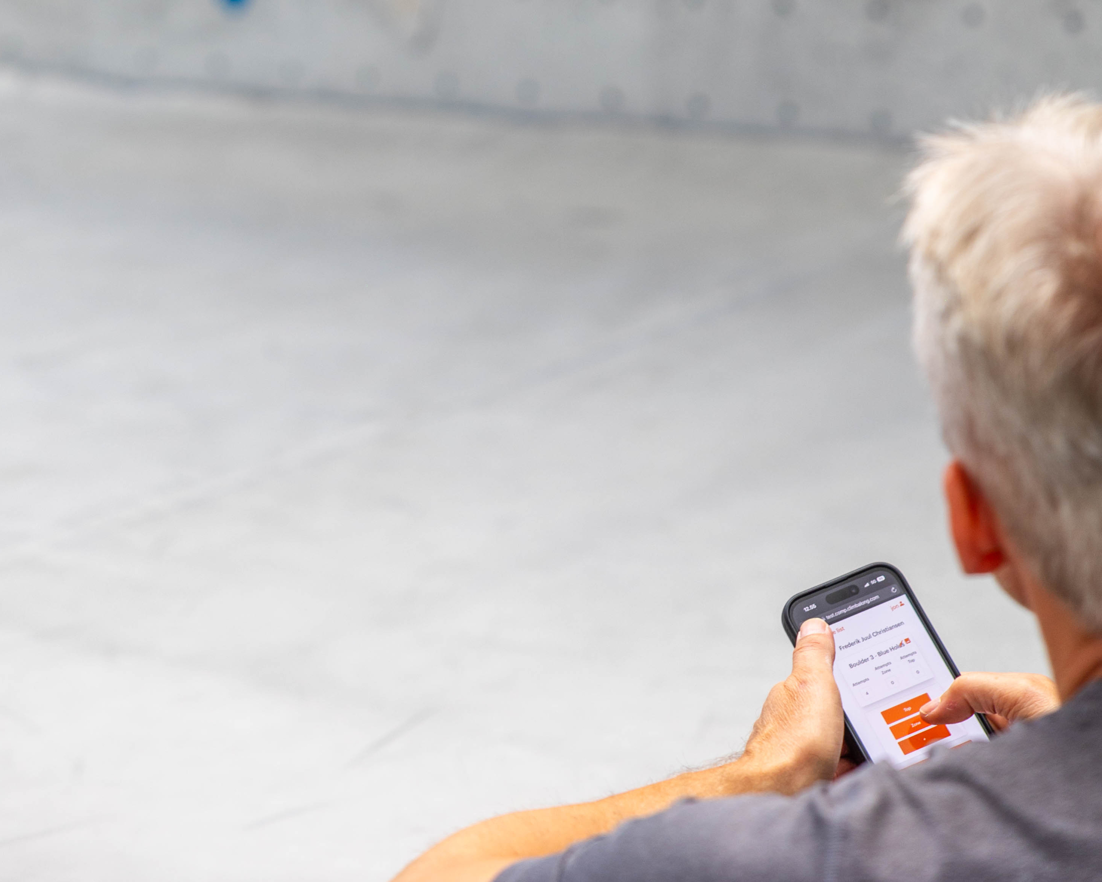 A judge entering scores in the ClimbAlong app